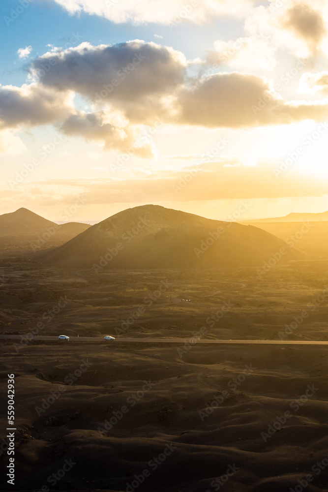 Beautiful sun rays over El Cuervo Volcano in Lanzarote, Canary Islands,  Spain