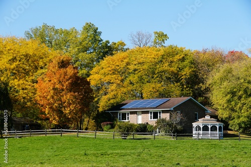 Fotografie A house with a solar system surrounded by beautiful fall foliage near Upstate New York, U