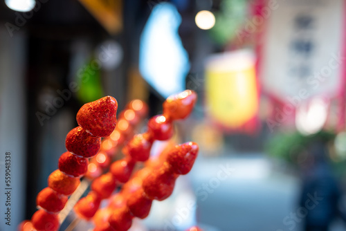 Tanghulu traditional Chinese hard caramel coated strawberry skewers close-up also called bing tanghulu candied hawthorn sticks
