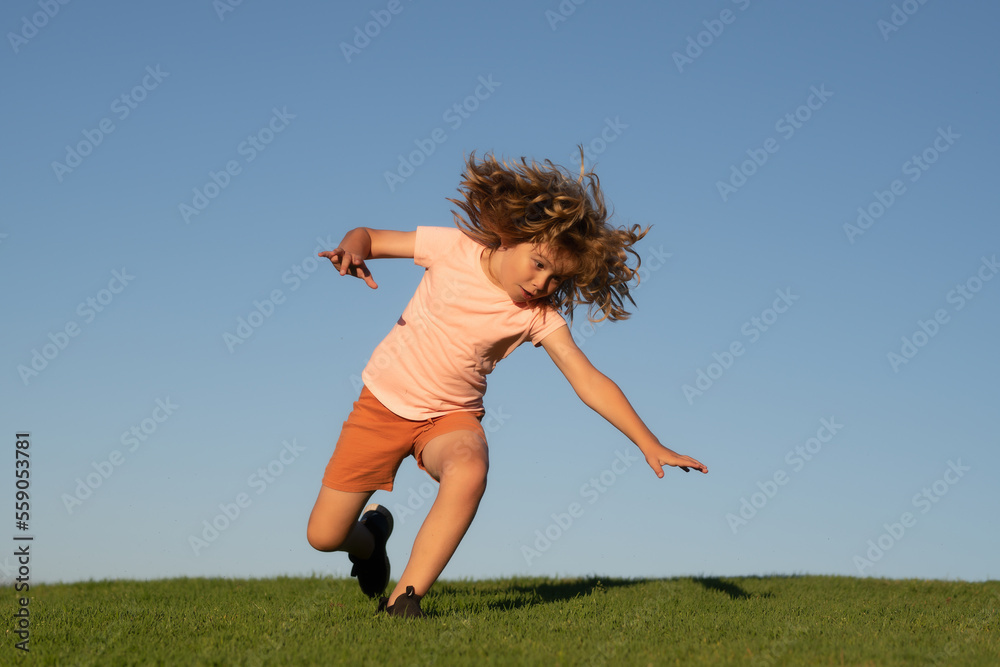 Kid falling down on the ground in summer park. Moment of the fall down.  Little child