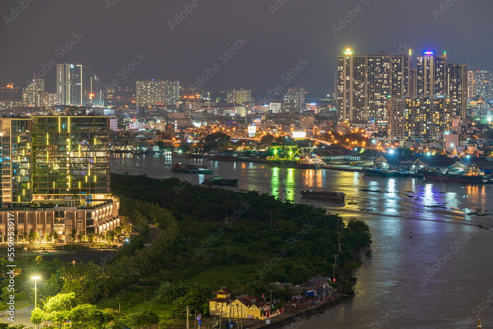 Naklejka premium HO CHI MINH, VIETNAM - April 29, 2022: Ho Chi Minh City at night, view to District 2, Thu Duc City, light trail, landmark 81