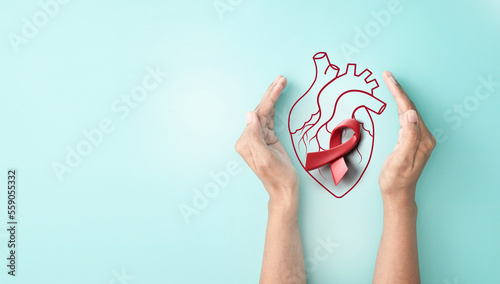 Hand hold 3d red awareness ribbon with line heart organ, heart disease awareness campaign, cardiovascular health, Stroke Prevention, hypertension (high blood pressure) for heart disease concept