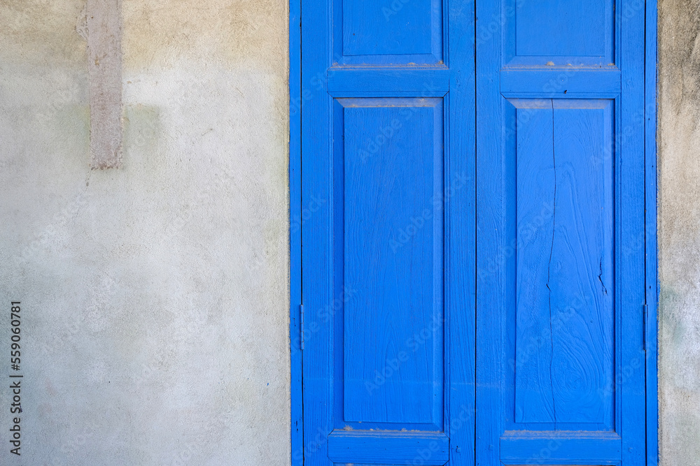 Blue Wooden Door with Old Grunge Concrete Wall Background. Blue Wooden Door with Old Grunge Concrete Wall Background.