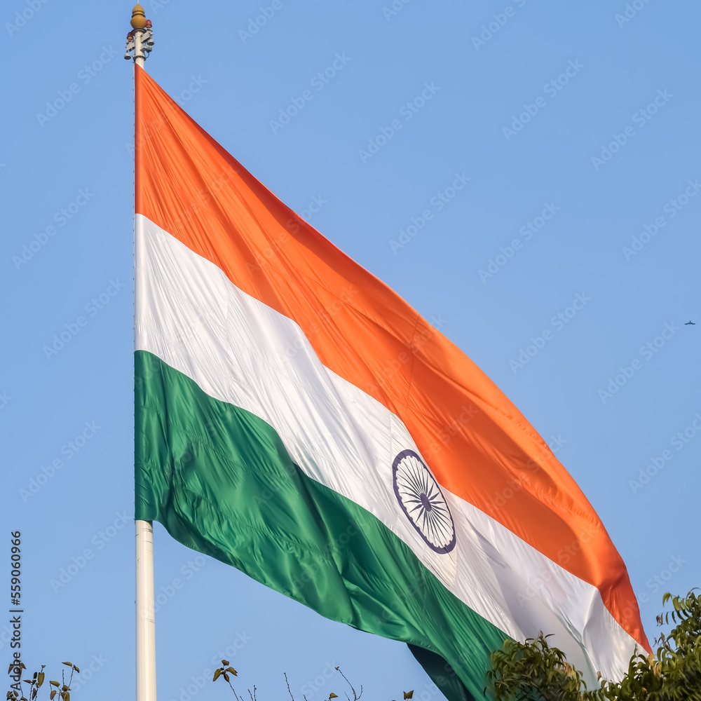 India flag flying high at Connaught Place with pride in blue sky, India