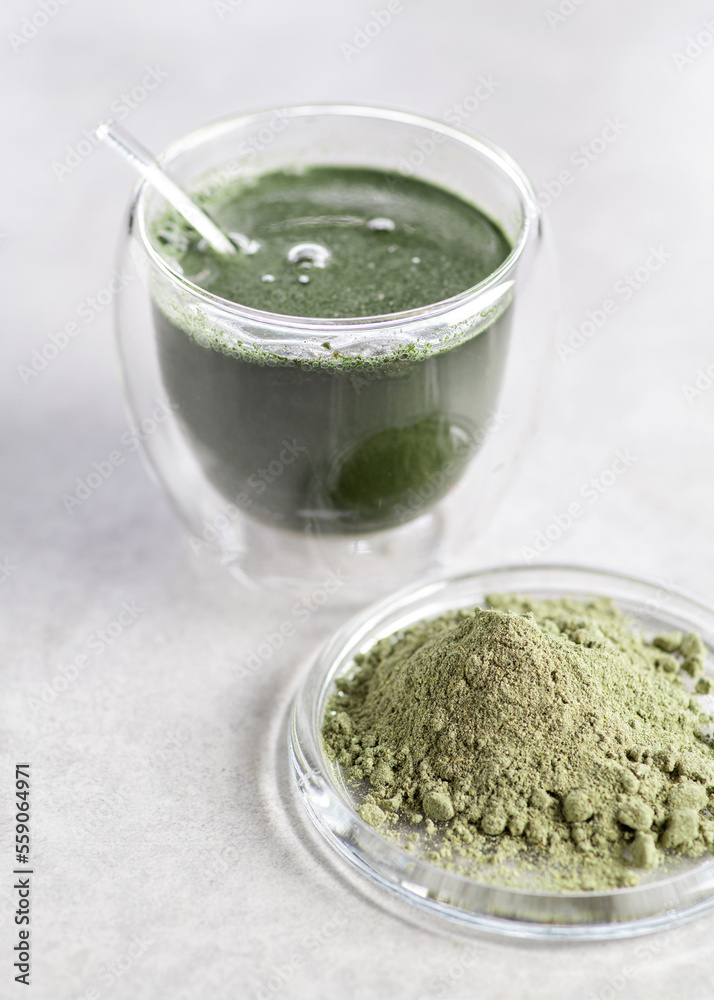 A source of biologically active substances, a food additive, herbal preparations, sprouted grains and vegetables, a superfood in dry form for adding to water and food, on a light background A source of biologically active substances, a food additive, herbal preparations, sprouted grains and vegetables, a superfood in dry form for adding to water and food, on a light background