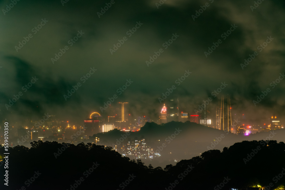 A dramatic and varied cloudy cityscape. Black is eerie and changeable. The hazy and dreamy twilight view of the city. Miaoli County, Taiwan