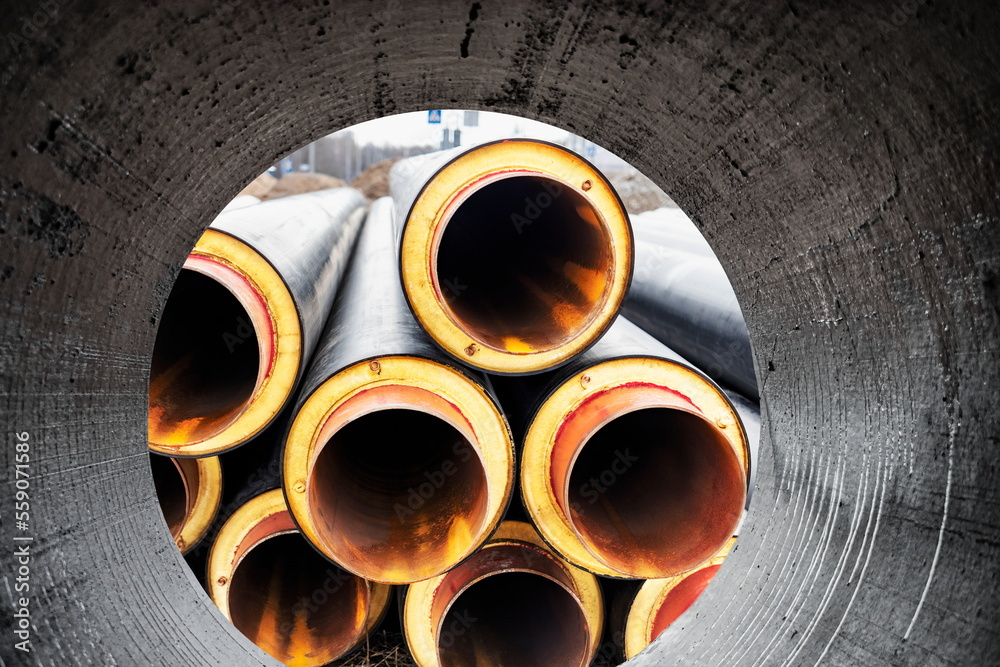 Insulated pipe. Large metal pipes with a plastic sheath at a construction  site. Modern pipeline for supplying hot water and heating to a residential  area. Close-up. Photos | Adobe Stock