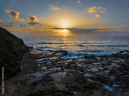 Sunrise over the ocean and rock platform © Merrillie
