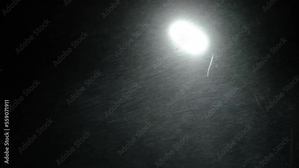 Strong snow blizzard in light of street lamp. Strong snow blizzard in light of street lamp.