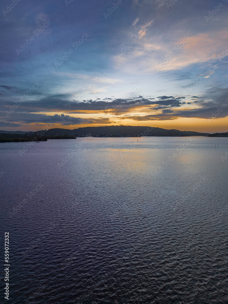 After the rain sunrise waterscape with clouds