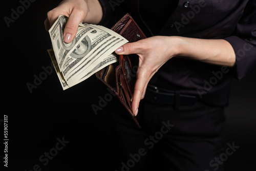 Young fun happy successful employee business woman 30s she wear casual brown classic jacket holding fan of cash money in dollar banknotes isolated on background studio portrait