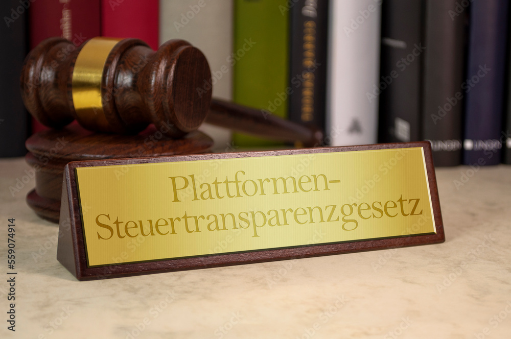 Golden sign on a desk with a special german law for tax transparency for online business - Plattformen-Steuertransparenzgesetz PStTG Golden sign on a desk with a special german law for tax transparency for online business - Plattformen-Steuertransparenzgesetz PStTG