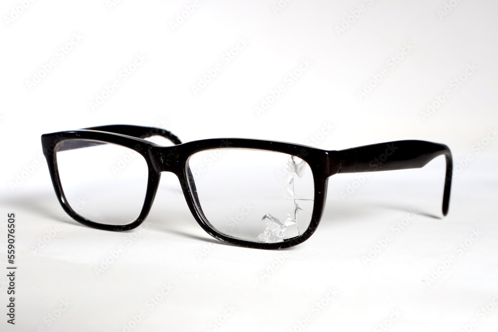 glasses with a dark frame, a broken lens on a white background glasses with a dark frame, a broken lens on a white background