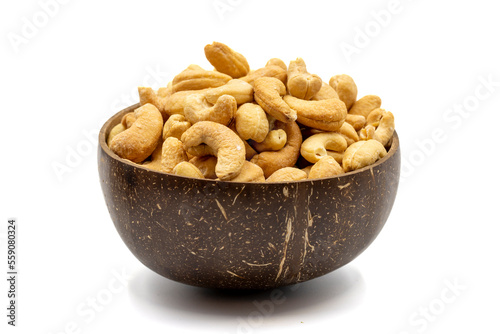 Cashew isolated on white background. Cashew in coconut bowl. Studio shoot. close up