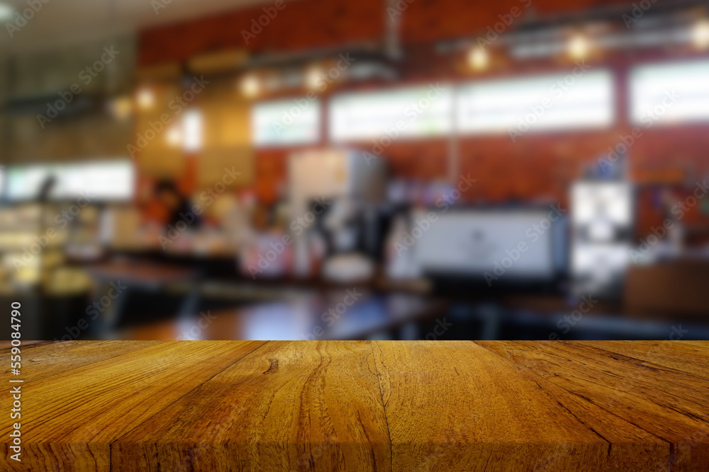 Wooden Table with Blurred Coffee Shop Background, Suitable for Food and Beverage Concept.