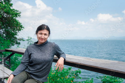 Woman (LGBTQ) posing at sea viewpoint with happy photo