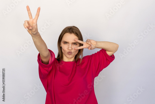 Fotografija Winsome young woman showing V-signs