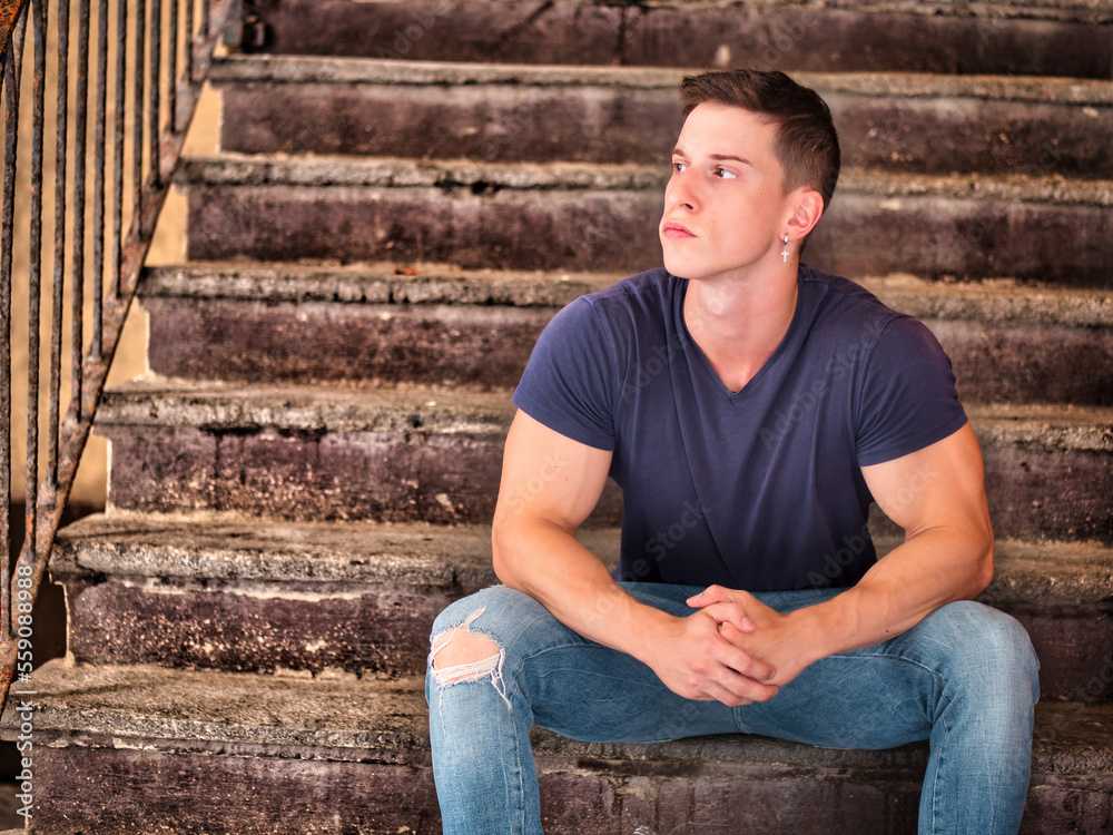 Handsome fit young man sitting on stairs Handsome fit young man sitting on stairs