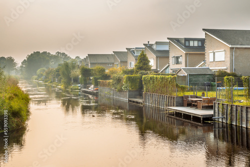 Homes on water edge in residential area photo