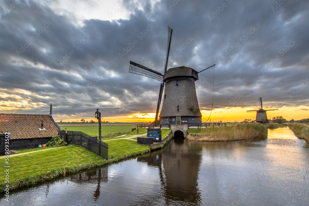 Traditional wooden windmill along canal
