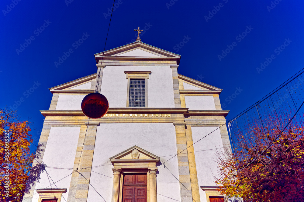 Entrance of white catholic church at the old town of Olten, Canton Solothurn, in bright sunlight on a sunny autumn day. Photo taken November 10th, 2022, Olten, Switzerland.