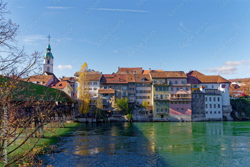 Medieval skyline of the old town of City of Olten, Canton Bern, with Aare River and wooden covered bridge on a sunny autumn day. Photo taken November 10th, 2022, Olten, Switzerland.