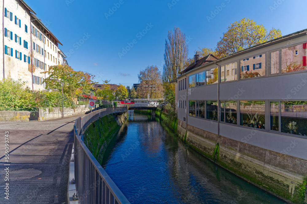 Facades of historic houses at the old town of Swiss City of Olten, Canton Solothurn, with canal on a sunny autumn day. Photo taken November 10th, 2022, Olten, Switzerland.