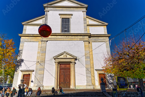 Entrance of white catholic church at the old town of Olten, Canton Solothurn, in bright sunlight on a sunny autumn day. Photo taken November 10th, 2022, Olten, Switzerland.