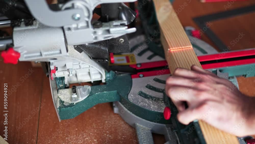 cutting wood with a miter saw. construction tool at work cutting wood with a miter saw. construction tool at work