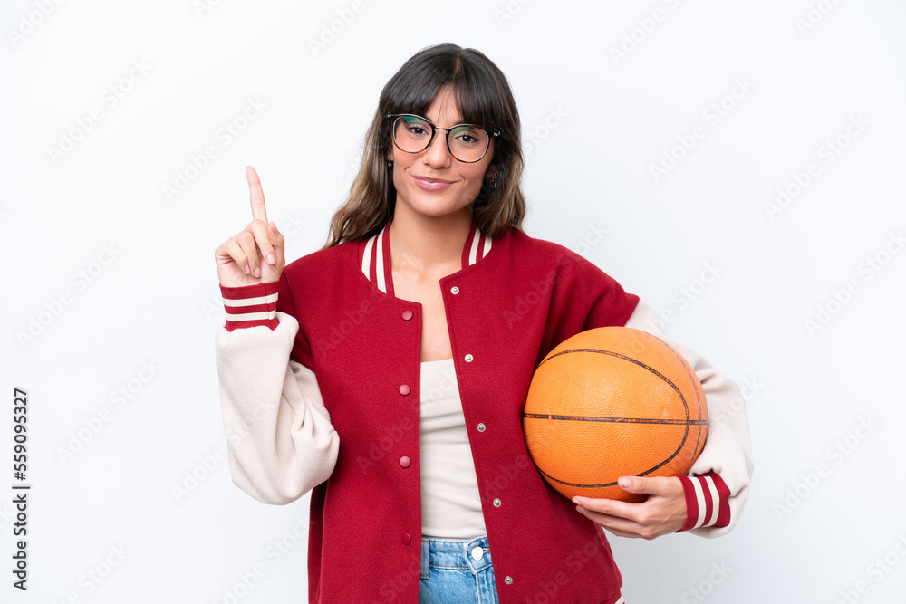 Young caucasian woman playing basketball isolated on white background showing and lifting a finger in sign of the best Young caucasian woman playing basketball isolated on white background showing and lifting a finger in sign of the best