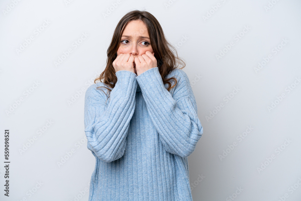 Young caucasian woman isolated on white background nervous and scared putting hands to mouth Young caucasian woman isolated on white background nervous and scared putting hands to mouth