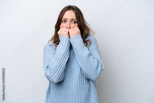 Young caucasian woman isolated on white background nervous and scared putting hands to mouth