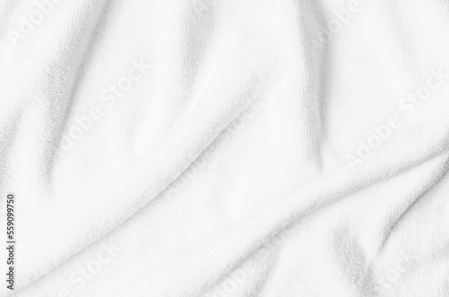 The Textured white natural cotton towel background photo with selective focus.