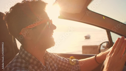 Wallpaper Mural Careless relaxed man in sunglasses driving cabriolet car at fantastic golden sunset. Sun flare. Concept of success, tourism, rental cars. Happy smiling tourist travel in California. Summer vacation Torontodigital.ca