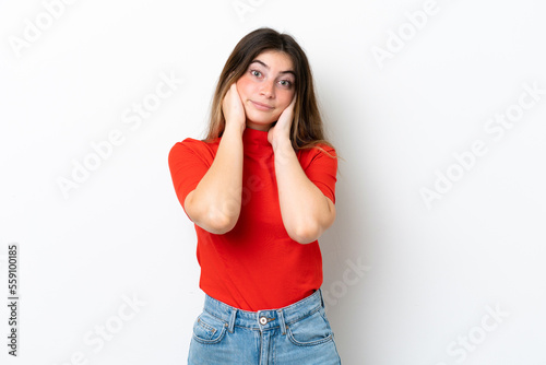 Young caucasian woman isolated on white background frustrated and covering ears