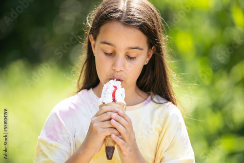Beautiful child girl holding ice cream with angry face, negative