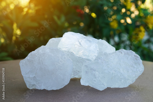 Crystal clear alum stones or Potassium alum on nature background.  Useful for beauty and spa treatment. Use to treat body odor under the armpits as deodorant and make water clear.  photo