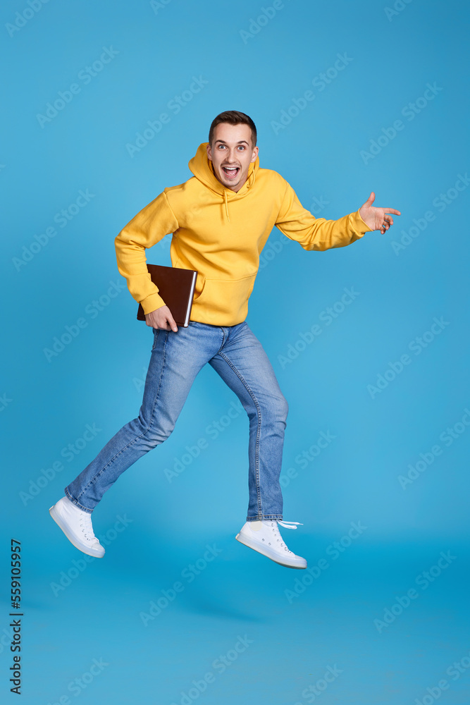 young happy man in casual clothes jumping young happy man in casual clothes jumping