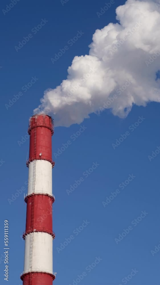 Powerful emissions into the atmosphere from the chimney of a thermal power plant in winter Powerful emissions into the atmosphere from the chimney of a thermal power plant in winter