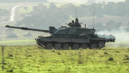 commander and gunner directing action in a British army FV4034 Challenger 2 ii main battle tank on a military combat exercise, Wiltshire UK