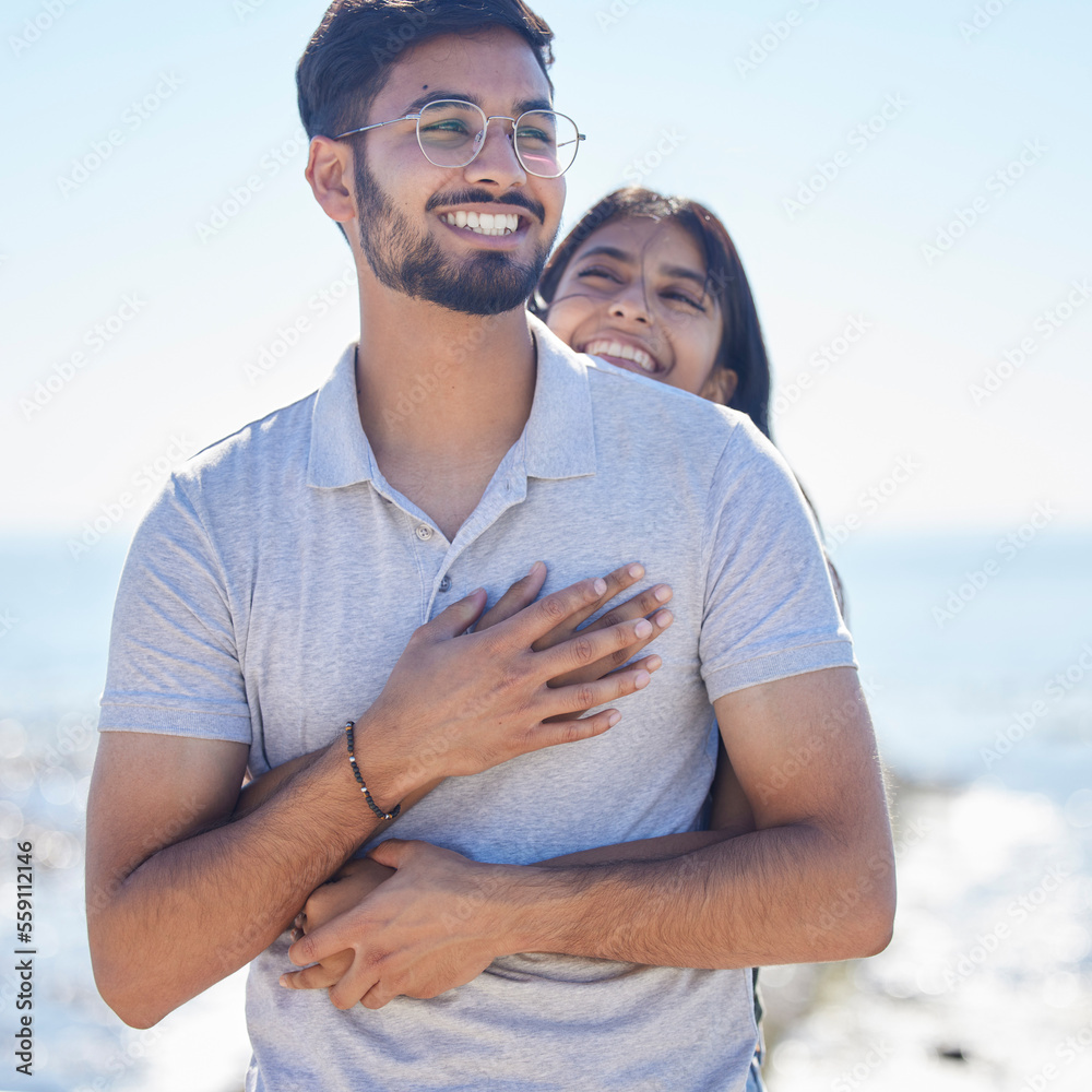 Hug, happy young couple at beach with travel and care on summer holiday by ocean, commitment and support outdoor. Partner, embrace and relationship with romantic date, man and woman on vacation Hug, happy young couple at beach with travel and care on summer holiday by ocean, commitment and support outdoor. Partner, embrace and relationship with romantic date, man and woman on vacation