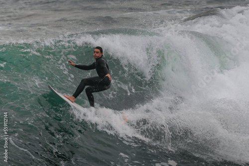 movement 1. young man surfs a wave in Telde, Gran Canaria. Canary Islands