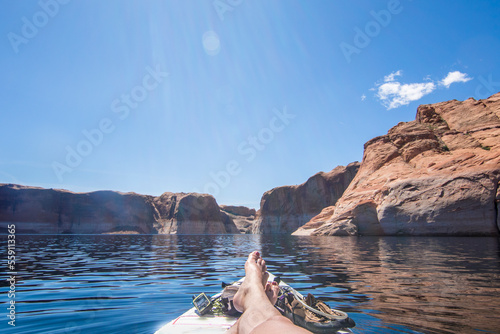 Woman relaxing on paddle board, Lake Powell, Utah, USA photo