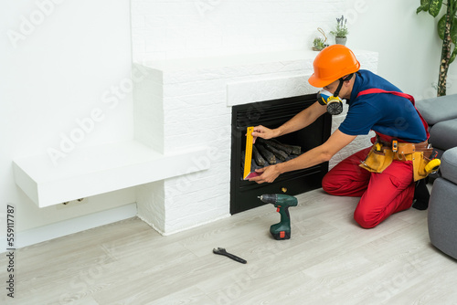 Fireplace installing in white brick wall.