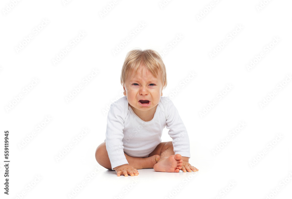 Little, happy and smiling cute baby in the studio. Portrait of a one year old baby. The concept of happiness. Little, happy and smiling cute baby in the studio. Portrait of a one year old baby. The concept of happiness.
