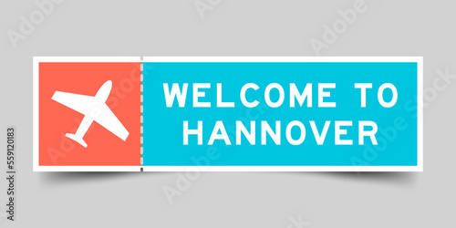 Orange and blue color ticket with plane icon and word welcome to hannover on gray background