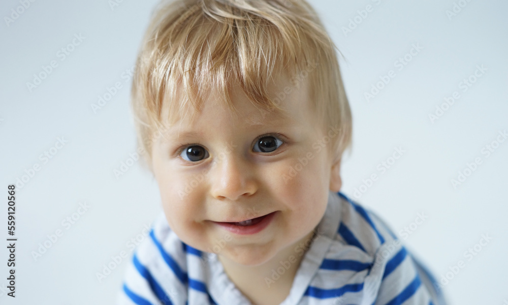 Little, happy and smiling cute baby in the studio. Portrait of a one year old baby. The concept of happiness. Little, happy and smiling cute baby in the studio. Portrait of a one year old baby. The concept of happiness.
