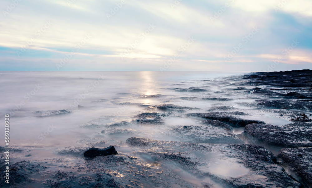 beautiful sun rise over the rocky coast in winter