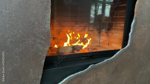 Slow motion footage of the burning flame behind the protective glass of a fireplace