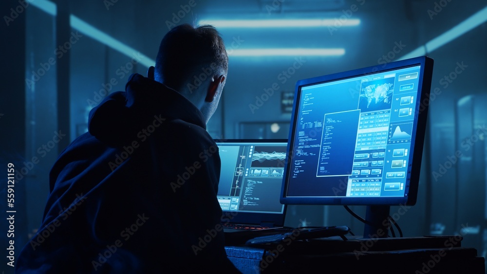 Computer Hacker in Hoodie. Obscured Dark Face. Concept of Hacker Attack, Virus Infected Software, Dark Web and Cyber Security. Computer Hacker in Hoodie. Obscured Dark Face. Concept of Hacker Attack, Virus Infected Software, Dark Web and Cyber Security.